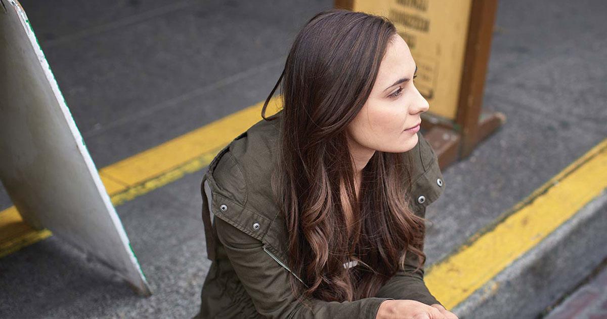 Sociology student Tatyana Lats sitting on curb